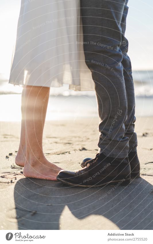 Crop bride and groom on sand Couple Groom Bride Sand Beach Stand Feet in love newlyweds Nature Coast Sunlight Relationship Beauty Photography Barefoot