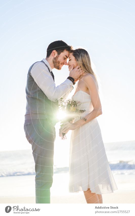 Bride with bouquet embracing groom Couple bridal Embrace Bouquet Feasts & Celebrations Wedding Nature romantic Beach Traveling Love Rustic Flower Together
