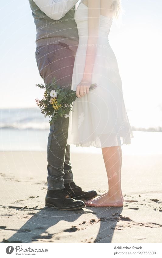 Crop bride with bouquet embracing groom Couple bridal Embrace Bouquet Feasts & Celebrations Wedding Nature romantic Beach Traveling Love Rustic Flower Together