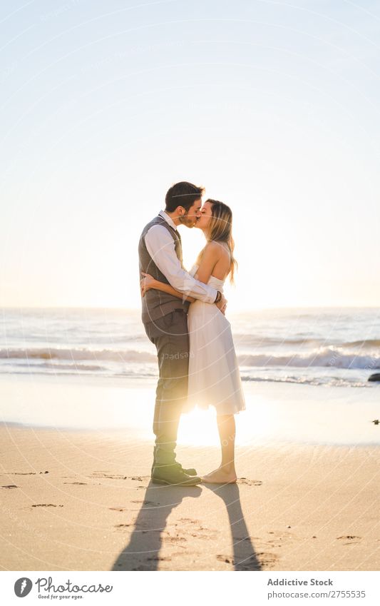 Tender kissing bridal couple in sunlight Couple Wedding Beach Sunlight embracing Engagement Contentment valentine enjoyment in love seascape Stand Relationship