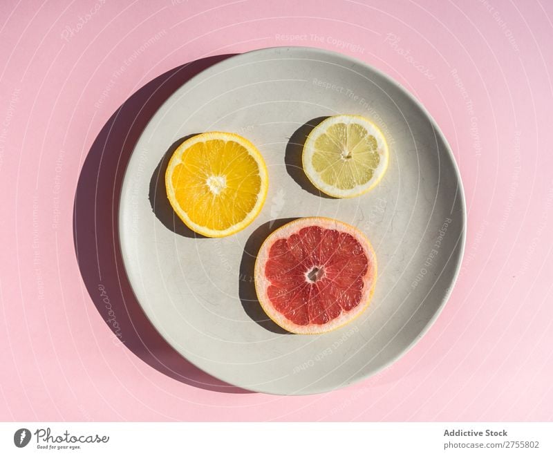 Slices of citrus on round plate Plate slices assortment Fresh minimalist Healthy Juicy Mix Grapefruit Lemon Natural dieting Orange Fruit Pink Delicious Diet