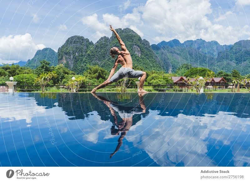 Man meditating on poolside Meditation Virgin forest Summer Vacation & Travel Harmonious Relaxation Athletic Swimming pool Mountain Peaceful Serene Resort