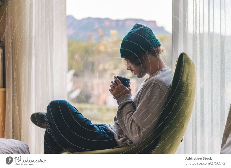 Man drinking coffee in armchair Coffee Armchair Cozy Relaxation Pensive Considerate Inspiration warming Hipster Cup Lounge chill Drinking Beverage Comfortable