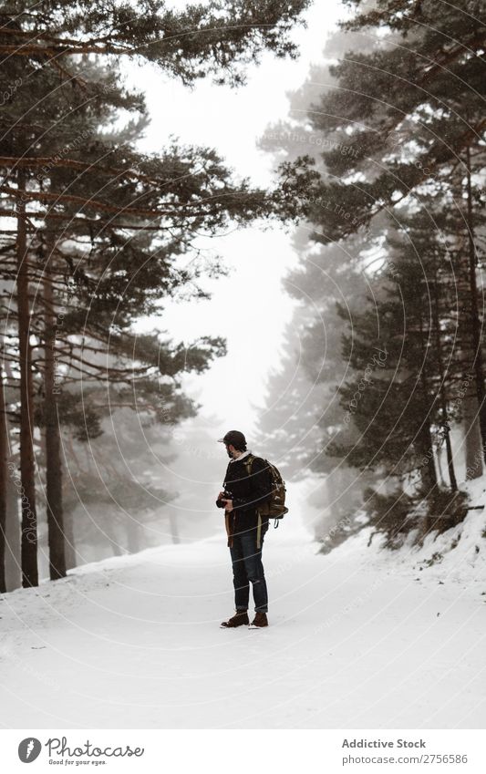 Tourist standing in snowy forest Man backpacker Street Stand Winter Forest Nature Snow Cold Frost Seasons Landscape White Beautiful Rural Looking back Frozen