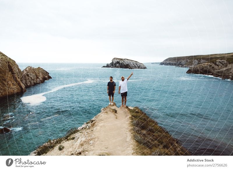 Men standing on cliff at ocean Man Tourist Ocean Rock Cheerful Friendship Together Stand Cliff Vacation & Travel Tourism Nature Landscape Coast Water Sun
