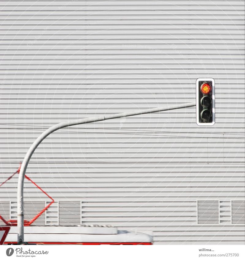 The traffic light is on red Traffic light Tram Corrugated iron wall Rail transport house wall Transport Means of transport Public transit Train travel Gray Stop