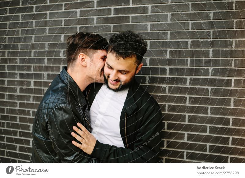 Man kissing his boyfriend Couple Homosexual Kissing Cheek Embrace Smiling Happy Stand Wall (building) Brick Posture In pairs Love 2 Together Lifestyle