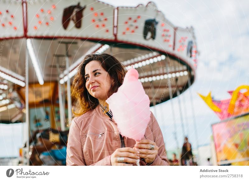 Cheerful woman with candy floss Woman Park Cotton candy Merry-go-round Human being Pink pretty Sweet Food To feed Sugar Joy Lifestyle Portrait photograph