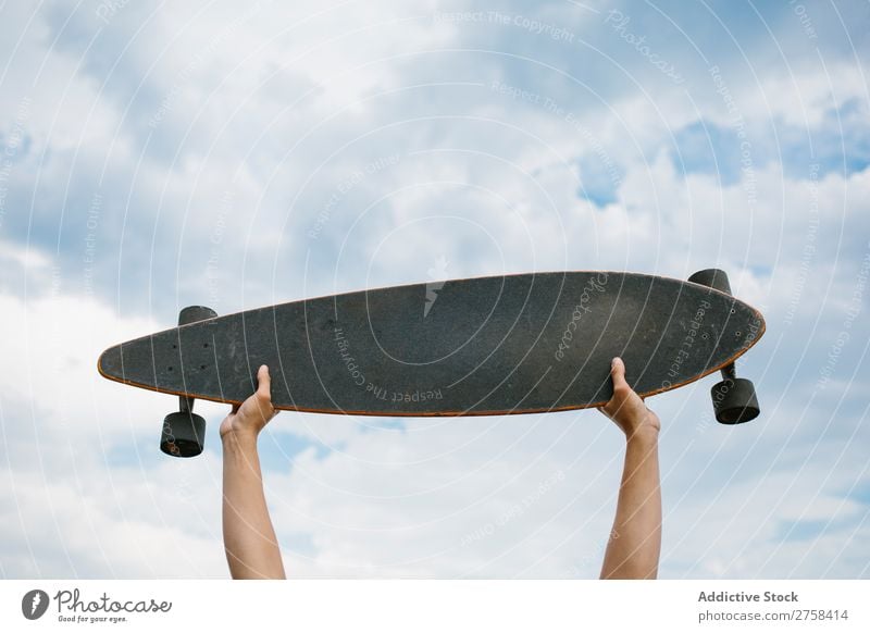 Hands holding skateboard Hold Skateboard Sky Clouds on high Crops Leisure and hobbies youngster Sports Ice-skates Skateboarding skateboarder Ice-skating Board