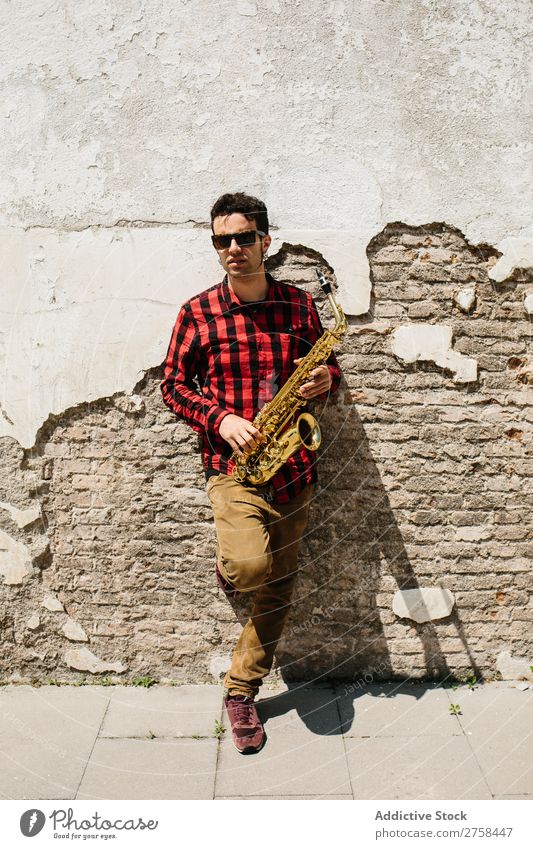 Cool musician with saxophone Musician Man Sunglasses Self-confident Cool (slang) Wall (building) Youth (Young adults) Jazz Saxophone instrument Musical