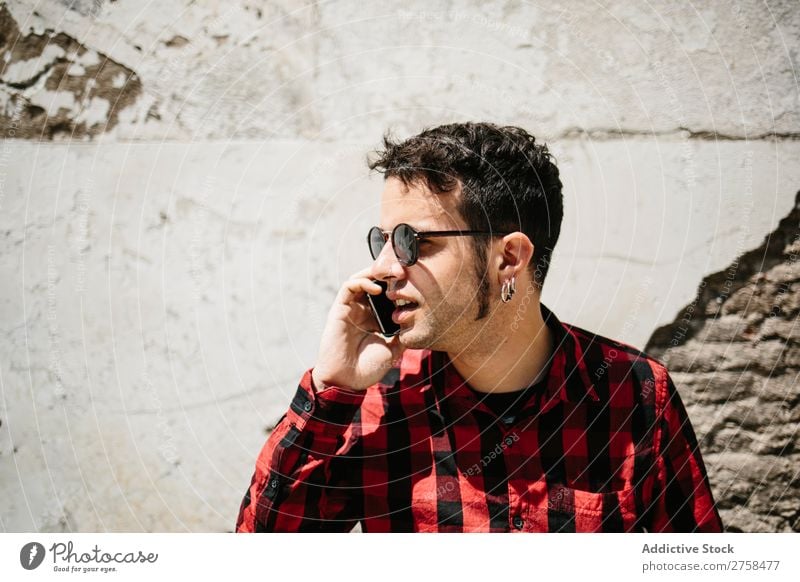 Stylish man talking phone Man PDA To talk Wall (building) Sunbeam Mobile handsome Style Cool (slang) Telephone Portrait photograph Lifestyle Communication