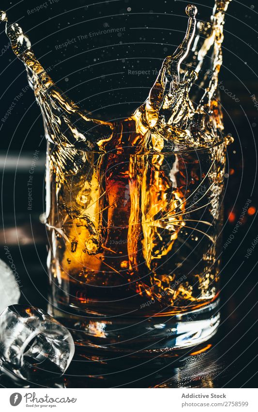 Splashes of glass of whiskey Alcoholic drinks Beverage Bourbon Brown Cocktail Cold Cool (slang) Crystal Cube Dark Drinking Drop Elegant Glass glassware Ice