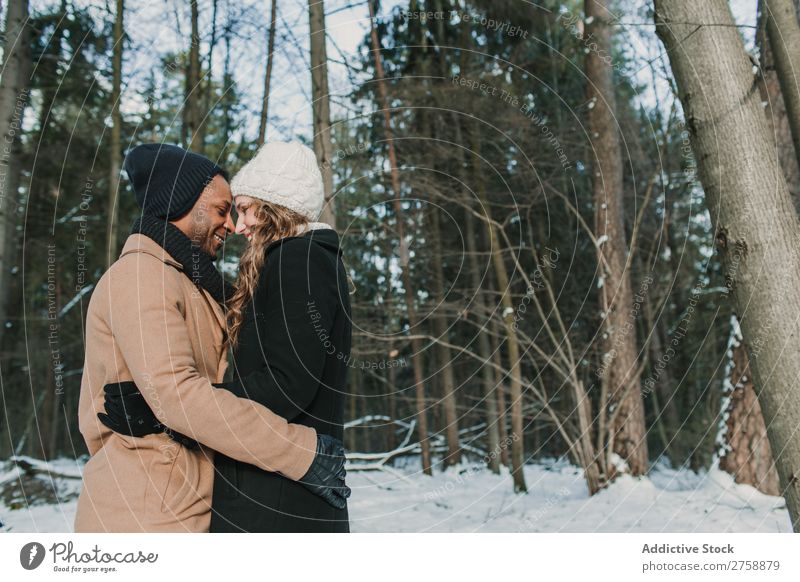 Couple posing in winter forest multiethnic Style warm clothes Easygoing Nature Forest Winter Snow piggyback Beautiful Mixed race ethnicity Black