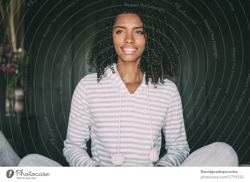 close up of a pretty black woman with curly hair smiling and lying on bed looking away Woman Bed Portrait photograph Close-up Lie (Untruth) Black Smiling