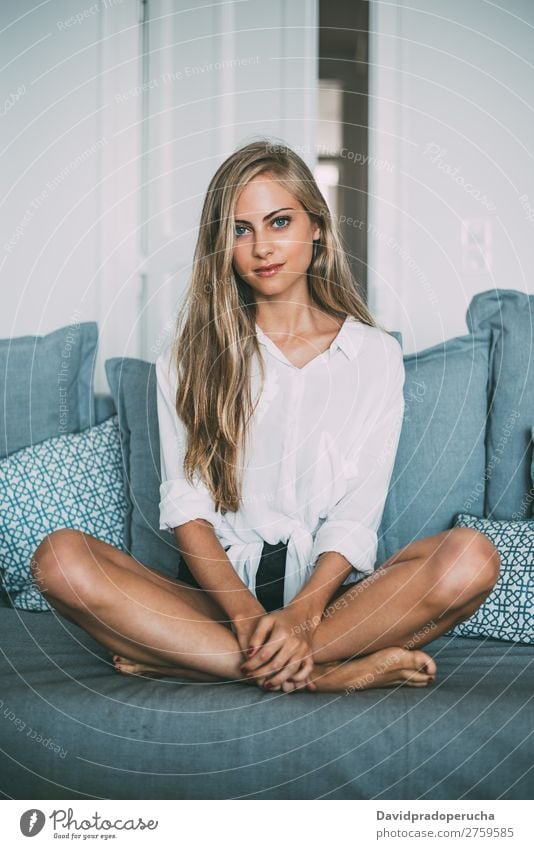young blonde Woman in a cozy sofa looking at camera Sit Sofa Couch Portrait photograph Room Smiling Youth (Young adults) Considerate pretty Close-up Life Home