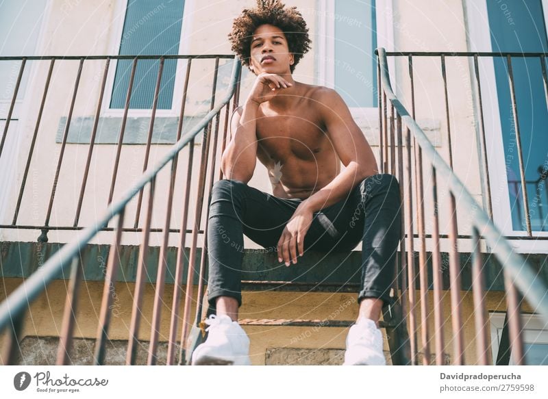 shirtless young black man sitting in the stairs Man Black Youth (Young adults) Athlete Naked Torso Human being Mixed race ethnicity Afro Curly hair Healthy Body