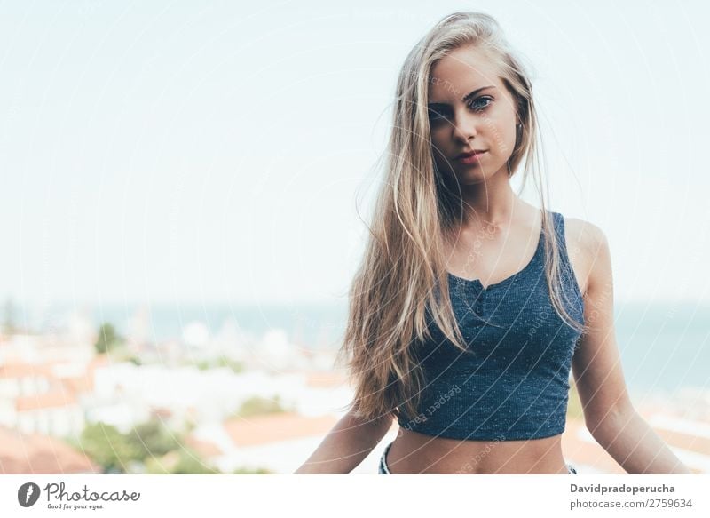 Portrait of a young fit beautiful healthy blonde woman posing Woman Portrait photograph Smiling Youth (Young adults) Considerate pretty Athletic Sit Blue Eyes