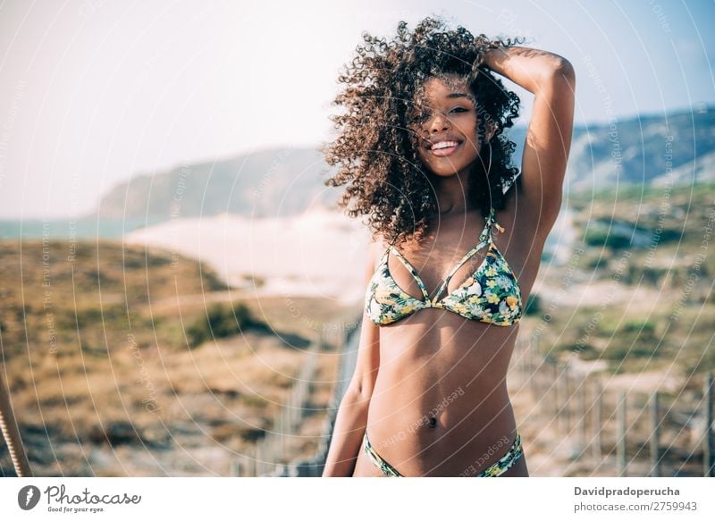 Beautiful young black woman in a wooden foot bridge at the beach Background picture Beach Bikini Black Bridge Coast Curly hair Destination Feet Hair