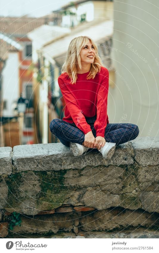 Happy young blond woman sitting on urban background. Lifestyle Style Beautiful Hair and hairstyles Human being Feminine Young woman Youth (Young adults) Woman