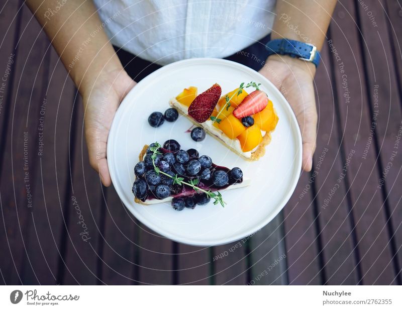 Close up hands holding plate of blueberry pie Cheese Fruit Dessert Plate Summer Restaurant Woman Adults Hand Fresh Delicious White background Bakery Blueberry