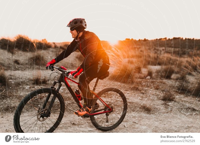 Cyclist Riding a bike at sunset. Sports Lifestyle Relaxation Leisure and hobbies Adventure Summer Sun Mountain Cycling Masculine Young man Youth (Young adults)