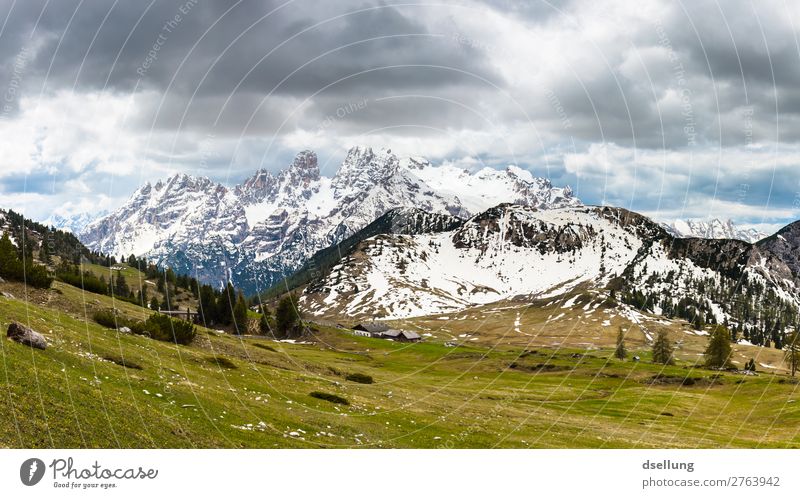 Snow-covered mountain peaks with cloudy sky Sunlight Picturesque Multicoloured Europe Climate Elements Tourism Clouds wide Large Tall Firm Gigantic Italy