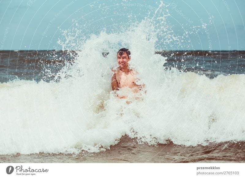 Young man enjoying the high waves in the sea Lifestyle Joy Happy Relaxation Leisure and hobbies Playing Vacation & Travel Summer Beach Ocean Human being