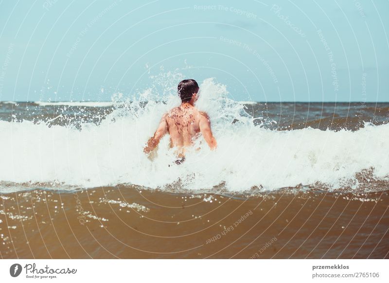 Young man enjoying the high waves in the sea Lifestyle Joy Happy Relaxation Leisure and hobbies Playing Vacation & Travel Summer Beach Ocean Human being