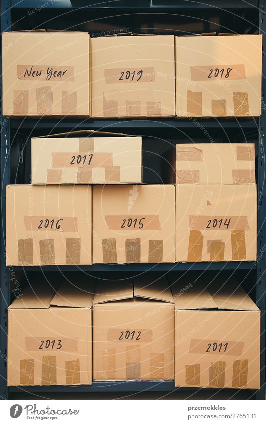 Cardboard boxes labeled number of years on shelves File Packaging Package Large Historic New Brown archive Carton depository distribution equipment many Order
