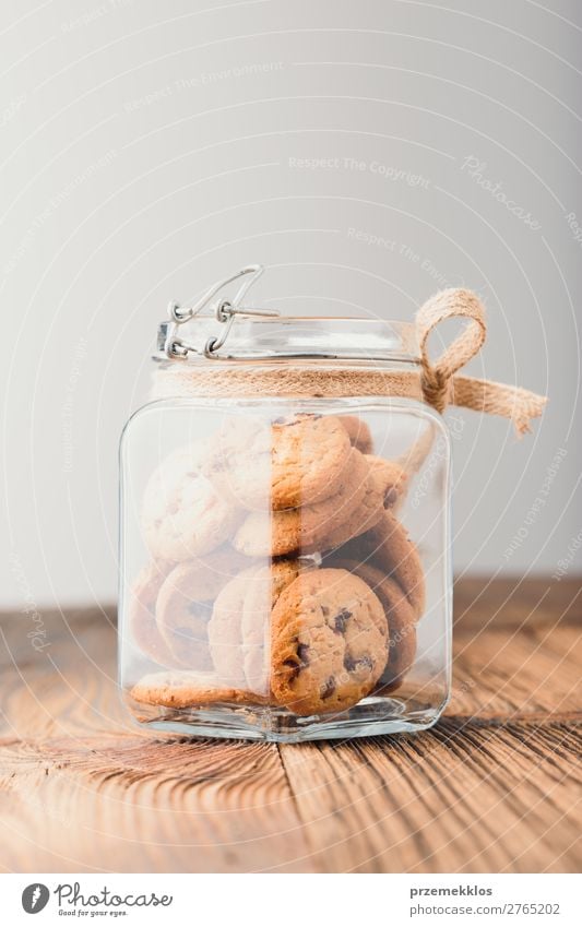 Big jar filled with oat cookies standing on a wooden table Dessert Nutrition Eating Diet Lifestyle Table To enjoy Delicious Brown Baking Bakery biscuit