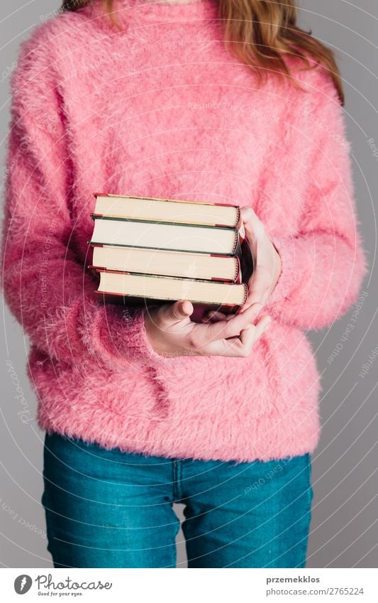 Young girl holding a few books Lifestyle Relaxation Leisure and hobbies Reading School Study Human being Woman Adults Youth (Young adults) Book Library Warmth