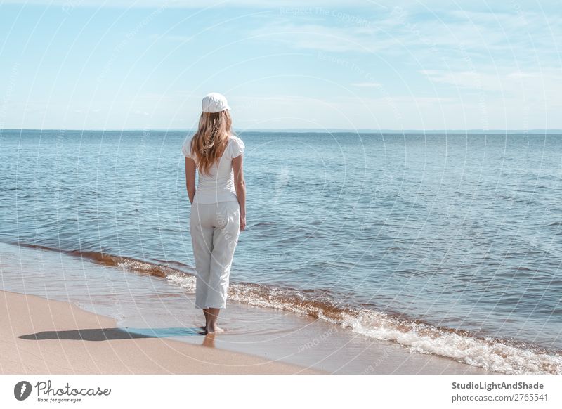 Young woman in white looking at water Lifestyle Beautiful Relaxation Calm Leisure and hobbies Vacation & Travel Tourism Beach Ocean Waves Human being Woman