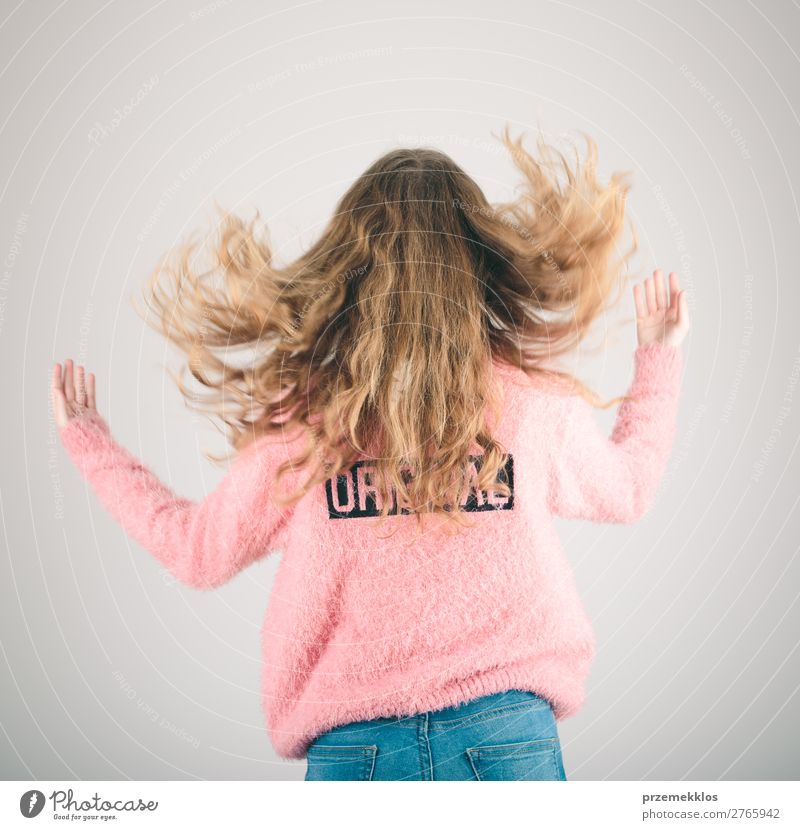 Back view of girl jumping in the air over plain background Joy Happy Relaxation Freedom Human being Woman Adults Youth (Young adults) 1 13 - 18 years Jeans