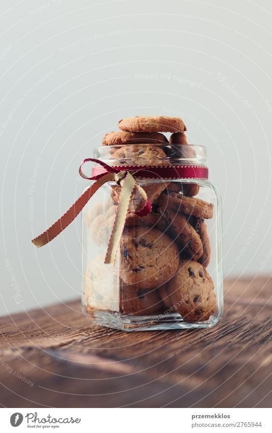 Big jar filled with oat cookies standing on a wooden table Dessert Nutrition Eating Diet Lifestyle Table To enjoy Delicious Brown Baking Bakery biscuit