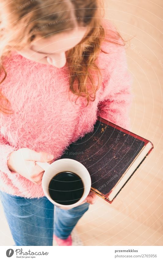 Girl holding book and cup of coffee going to relax with a book Coffee Lifestyle Relaxation Leisure and hobbies Reading Child Human being Woman Adults Book