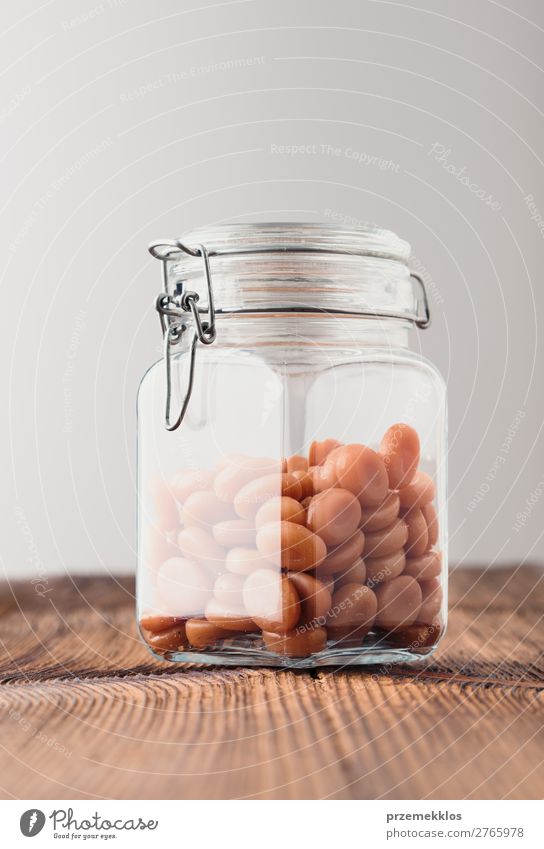 Jar filled with caramel milky candies on wooden table Dessert Nutrition Eating Diet Table Wood Delicious addiction candy Caramel eat food jar Quit Objective