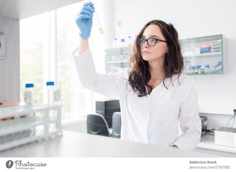 Woman looking at test tube Laboratory Work and employment Science & Research Test tube Reaction Observe Human being Scientist Medication Chemistry Technology
