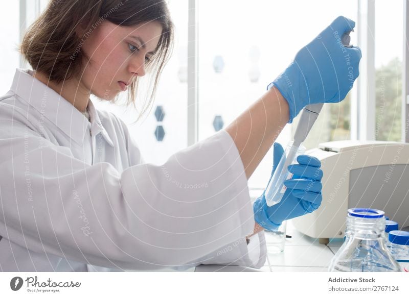 Worker putting liquid to test tube Laboratory Work and employment Science & Research Woman Test tube Liquid pouring Putt Human being Scientist Medication