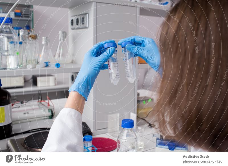 Worker watching test tubes Laboratory Work and employment Science & Research Woman Test tube Liquid pouring Putt Human being Scientist Medication Chemistry