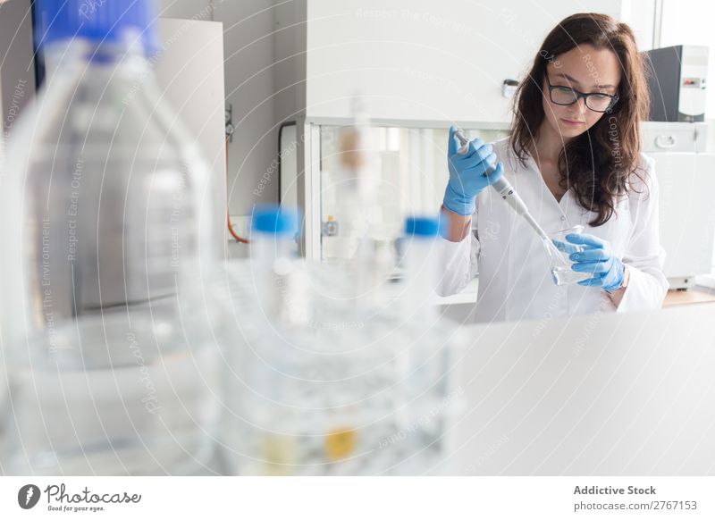 Woman holding flask in lab Laboratory Work and employment Science & Research Erlenmeyer flask Glass Scientist Medication Chemistry Technology Doctor experiment