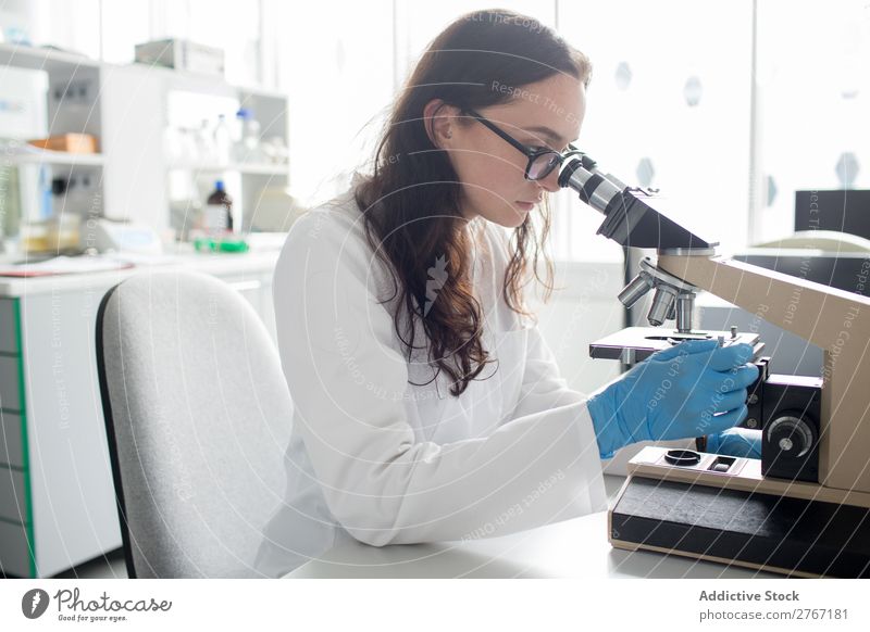 Woman looking at microscope Laboratory Work and employment Science & Research Microscope Observe Human being Scientist Medication Chemistry Technology Doctor