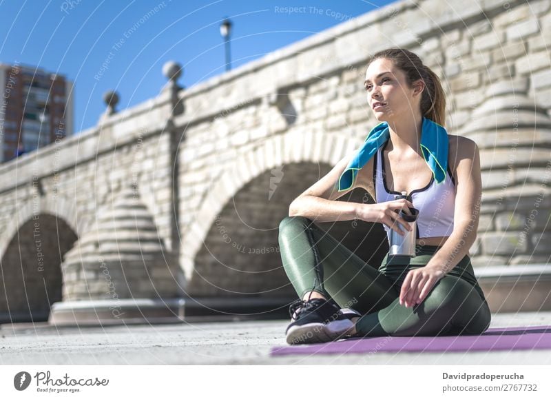 Woman resting and drinking water with towel after workout Lifestyle Beautiful Body Relaxation Meditation Sports Yoga Human being Adults Nature Warmth Park