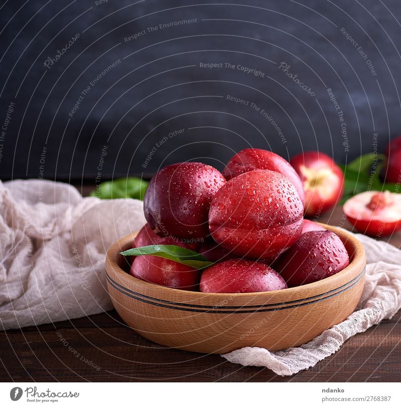 ripe peaches nectarine in a brown wooden bowl Fruit Dessert Nutrition Vegetarian diet Plate Bowl Summer Table Group Leaf Wood Eating Fresh Delicious Natural