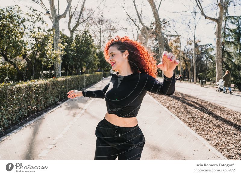Latin woman dancing on the street. Lifestyle Style Joy Happy Leisure and hobbies Freedom Music Dance Sports Woman Adults Dancer Street Fashion Movement Fitness