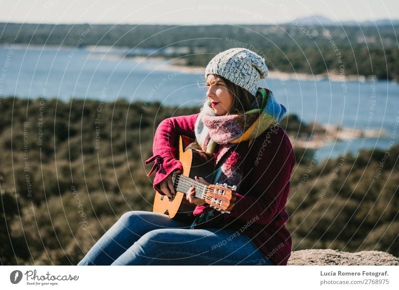 Woman playing guitar outdoors. Lifesytle Lifestyle Joy Happy Relaxation Leisure and hobbies Playing Vacation & Travel Winter Music Human being Feminine Adults