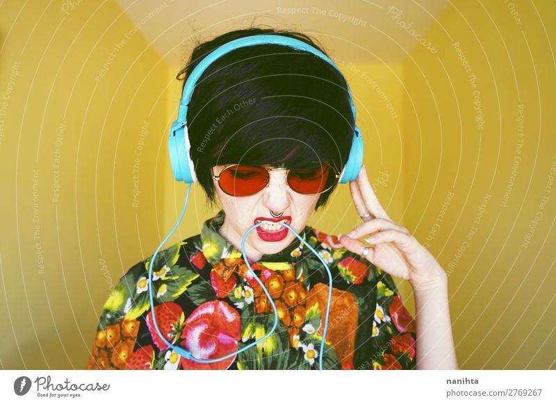 Cool androgynous dj woman in vibrant colors - a Royalty Free Stock Photo  from Photocase