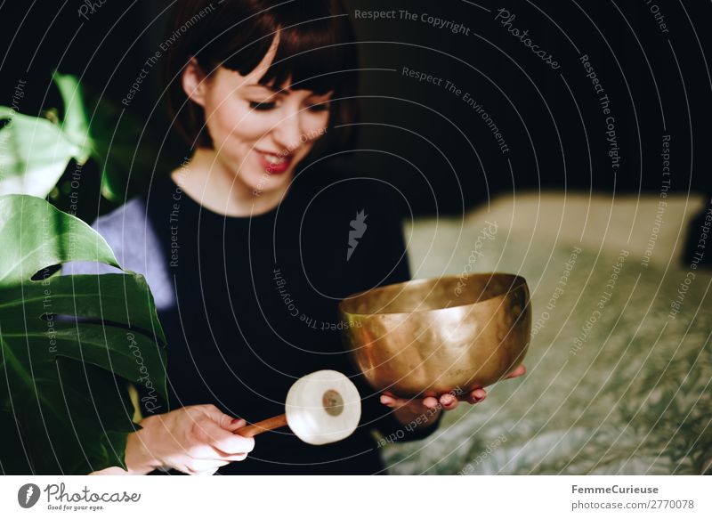 Mindfulness - Woman with singing bowl in her cozy home Feminine Adults 1 Human being 18 - 30 years Youth (Young adults) 30 - 45 years Contentment Relaxation