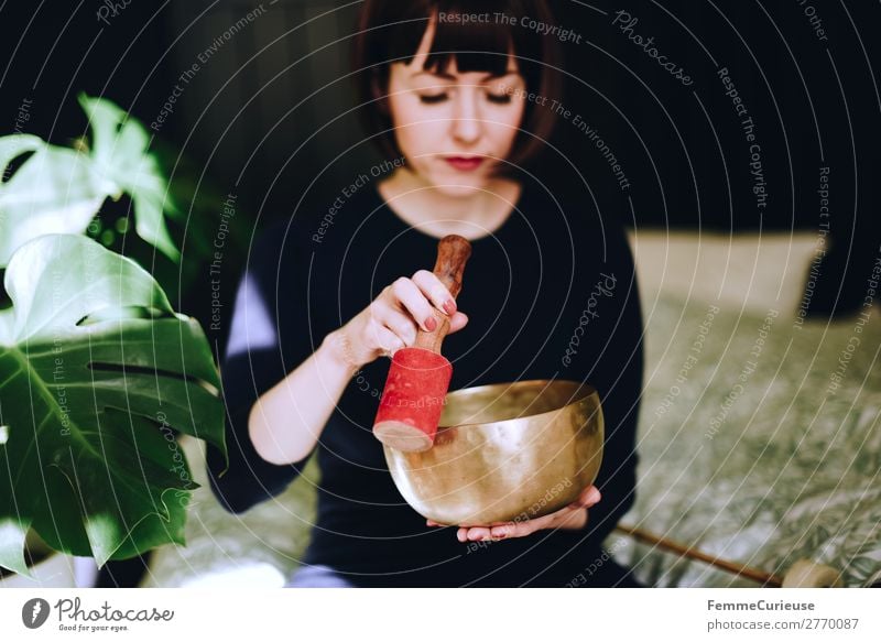 Mindfulness - Woman with singing bowl in her cozy home Lifestyle Leisure and hobbies Feminine Adults 1 Human being 18 - 30 years Youth (Young adults)