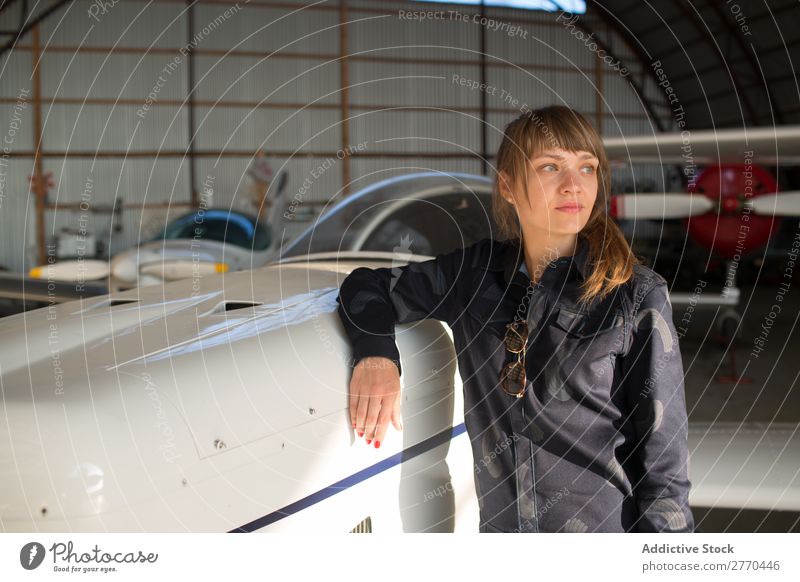 Girl posing in hangar Woman Hangar Airplane Posture Aviation Engineer Maintenance Freedom Transport Youth (Young adults) Leisure and hobbies Self-confident