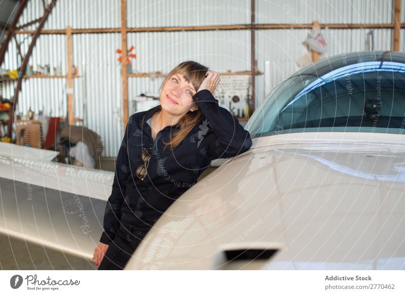 Girl posing in hangar Woman Hangar Airplane Posture Aviation Engineer Maintenance Freedom Transport Youth (Young adults) Leisure and hobbies Self-confident